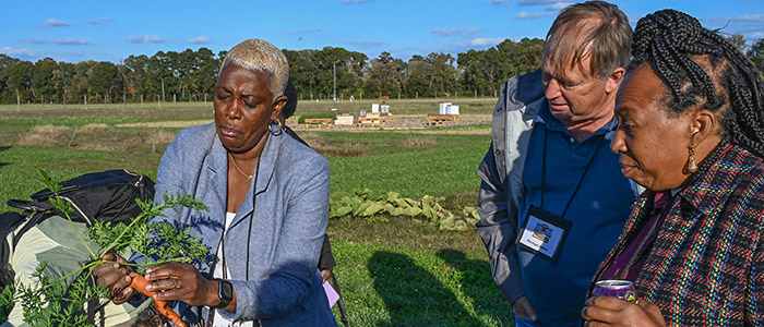 Alternative Crop Specialist Dr. Nadine Burton shows some of the crops grown at the UMES farm.