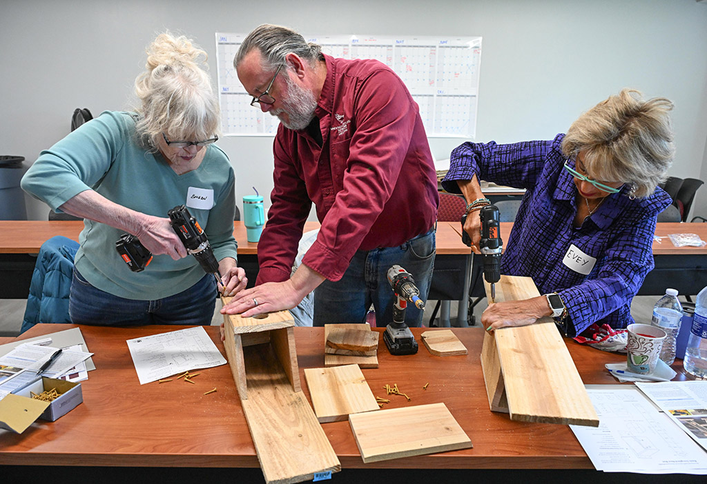 Stephen Goewey helps participants build birdhouses at a workshop.