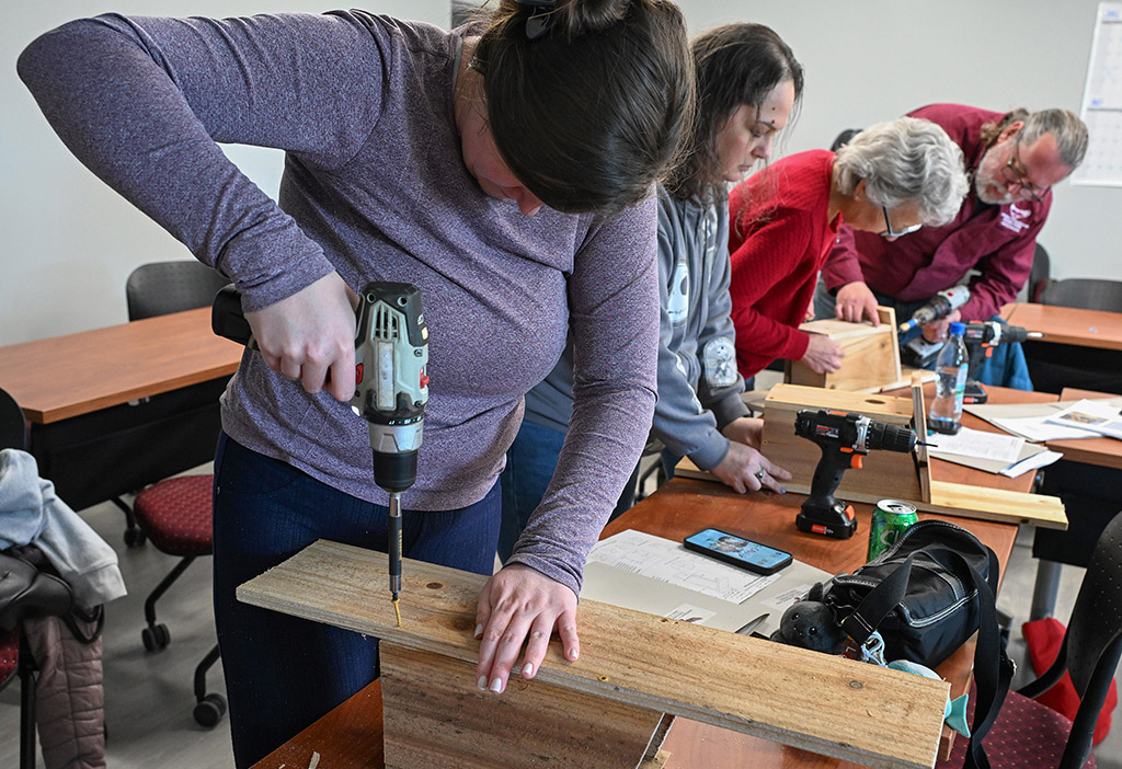 Workshop participants build their birdhouses.