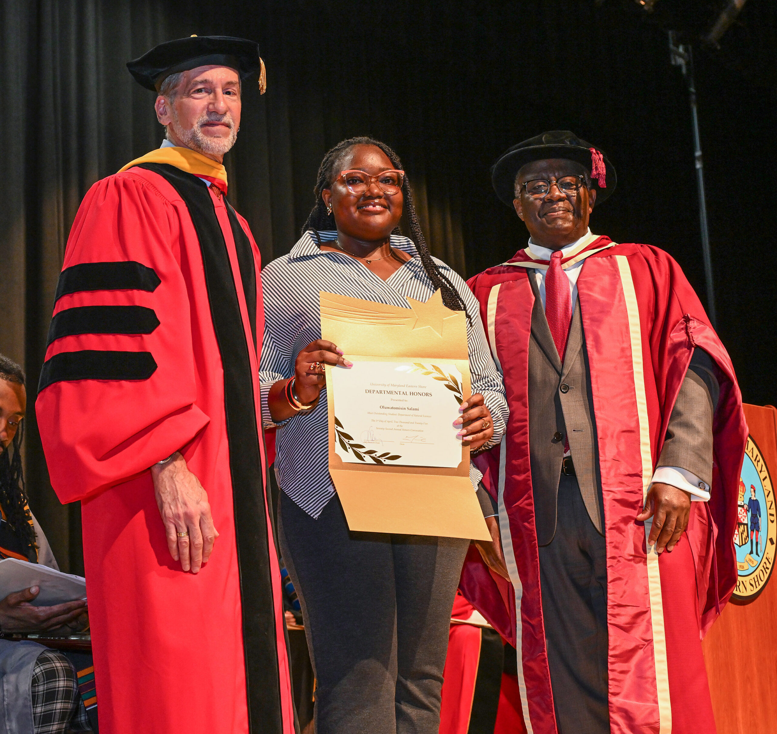 Oluwatomisin Salami, Dept. of Natural Sciences honoree, with Chair Dr. Jonathan Cumming and Dean Dr. Moses T. Kairo.