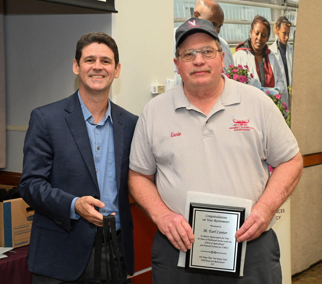 Retiring farm manager Merton "Eric" Canter, right, with Dr. Vagner Benedito, Associate Dean of 1890 Research.
