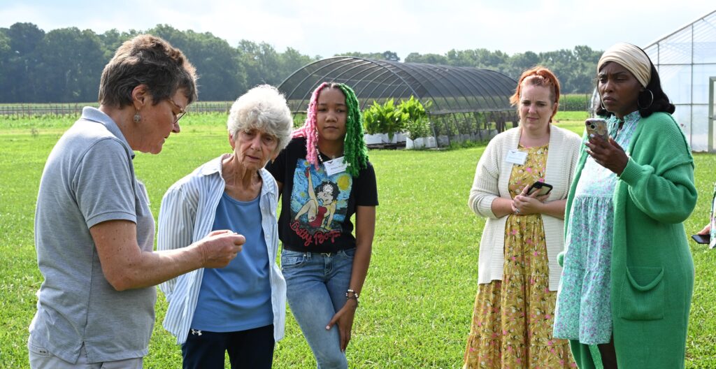 Herb specialist Henriette den Ouden, left, offers a lesson in growing, harvesting and processing the plants.