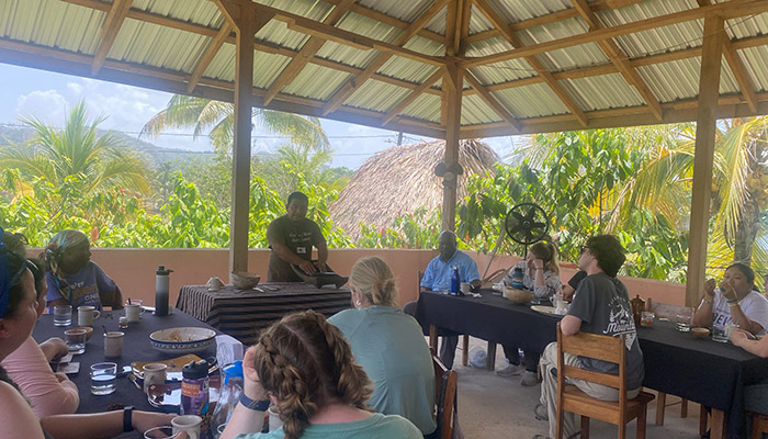 Students watch demonstration of chocolate processing. Photo courtesy Stephan Tubene.