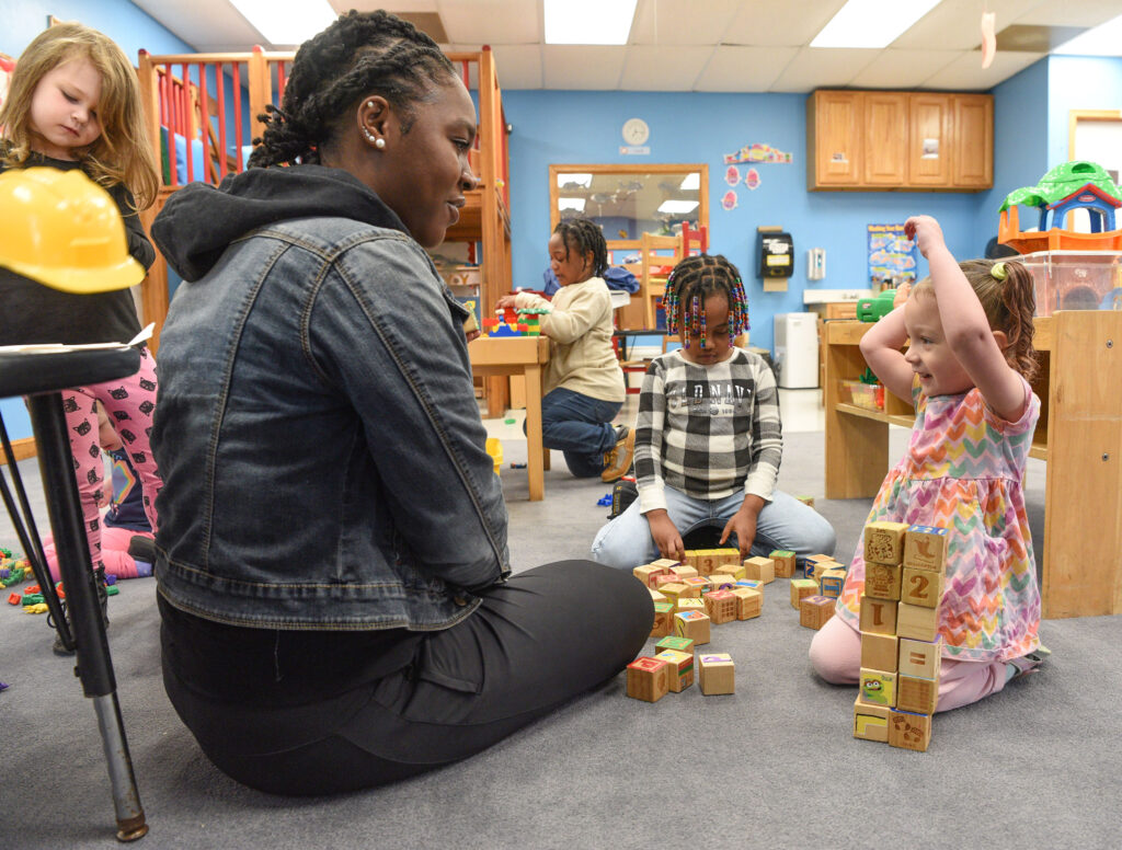 A UMES Child and Family Development Center employee helps a child during a block building developmental activity. Photo by Todd Dudek, UMES Extension.