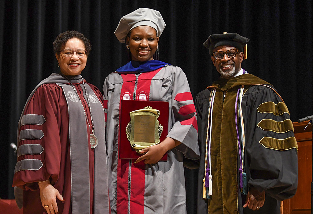 UMES President Heidi Anderson presents a plague to UMES alumna Yasmin Roye for giving the Honors Convocation keynote address.  Far right is Dr. Rondall Allen, provost and vice president for academic affairs.