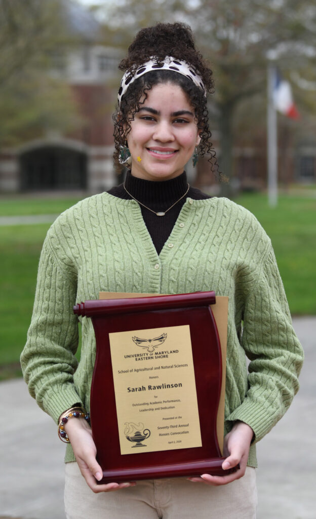 Sarah Rawlinson holds a plaque for the Award of Excellence for the School of Agricultural and Natural Sciences at the 73rd annual Honors Convocation.