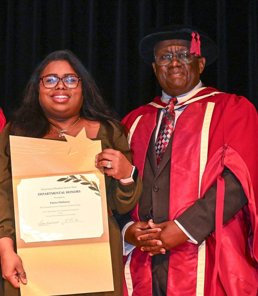 Patrice Dolloway holds a certificate for the outstanding student for UMES' Department of Human Ecology presented by Moses T. Kairo, dean of the School of Agricultural and Natural Sciences.
