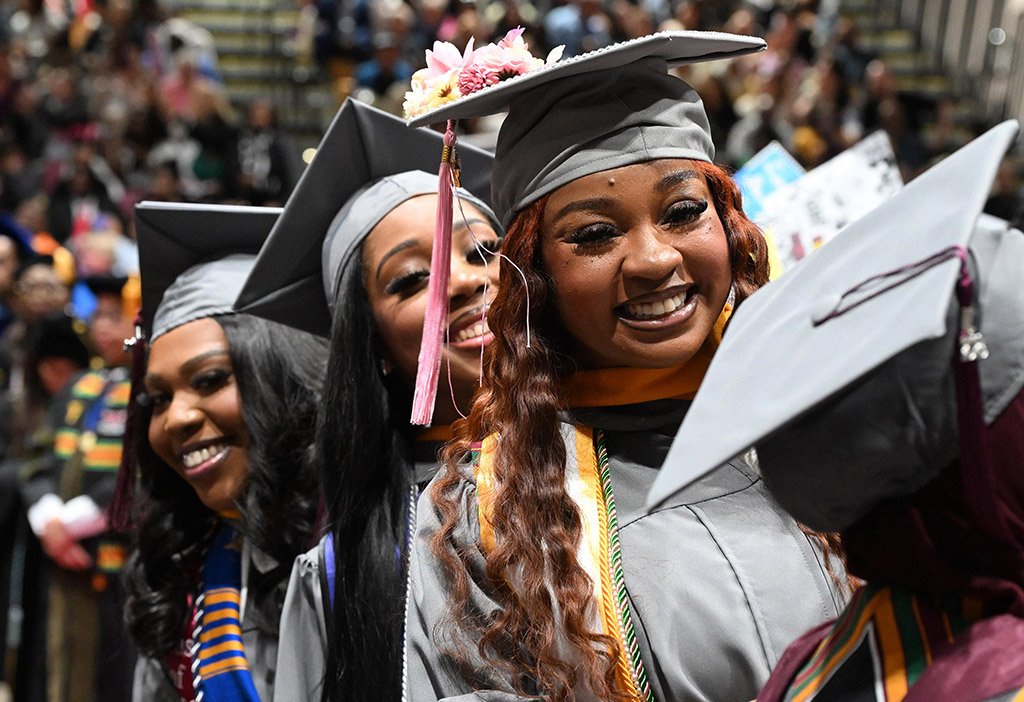 Biology majors, from left, Krystin Rogers, Liyah English and Aniya Hood smile to the crowd during the 139th Spring Commencement.