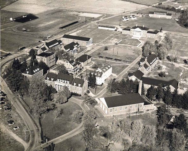 By the mid-1950s, the Academic Oval began to define Maryland State College. Somerset and Harford, Wilson, Waters and Murphy halls were added along with Trigg Hall and a football field. Student cadets and a band are in formation between Somerset amd Murphy halls, which were men's and women's dorms, respectively.