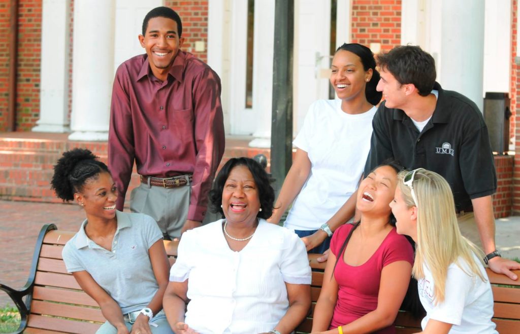 President Thompson laughs with students on the grounds of UMES
