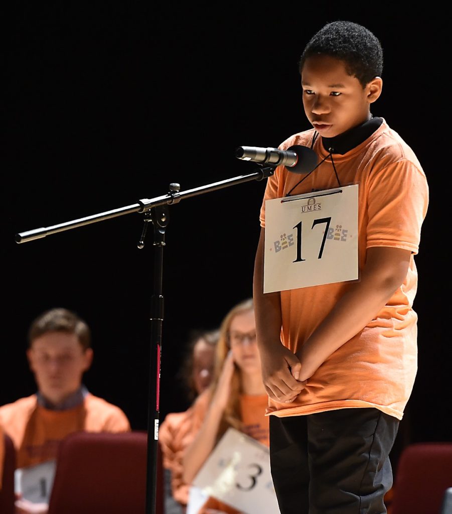 Student at microphone in the spelling bee competition