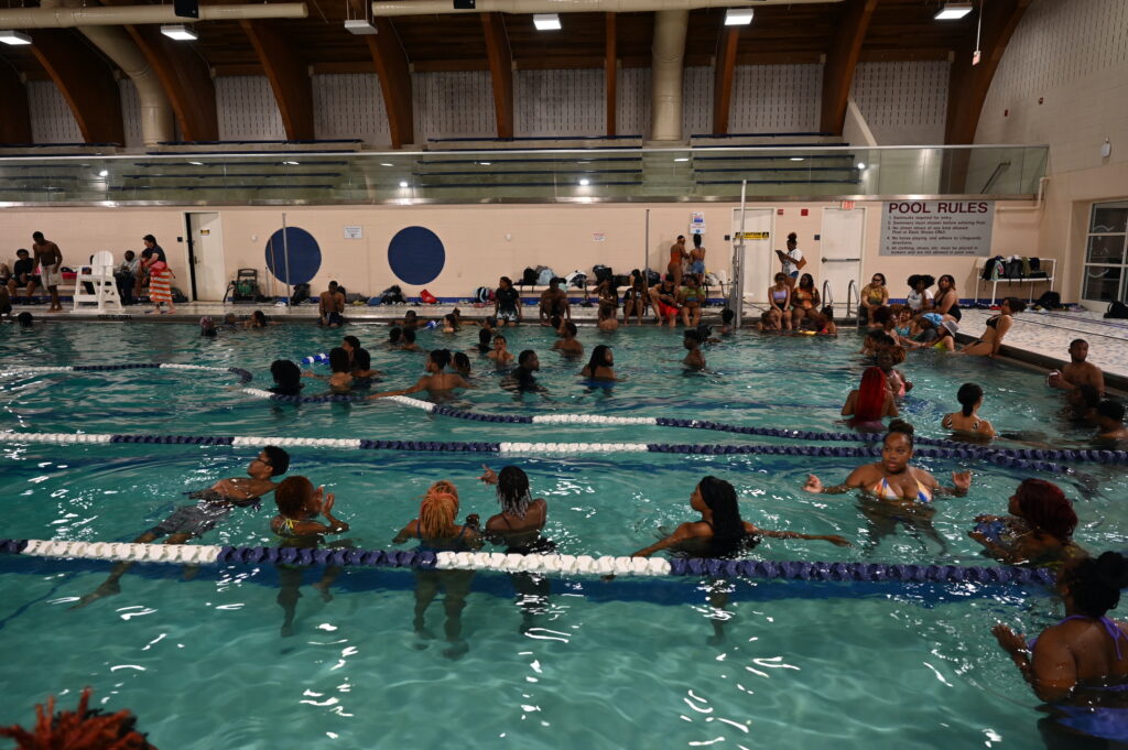 African American College Students Swimming in a Pool