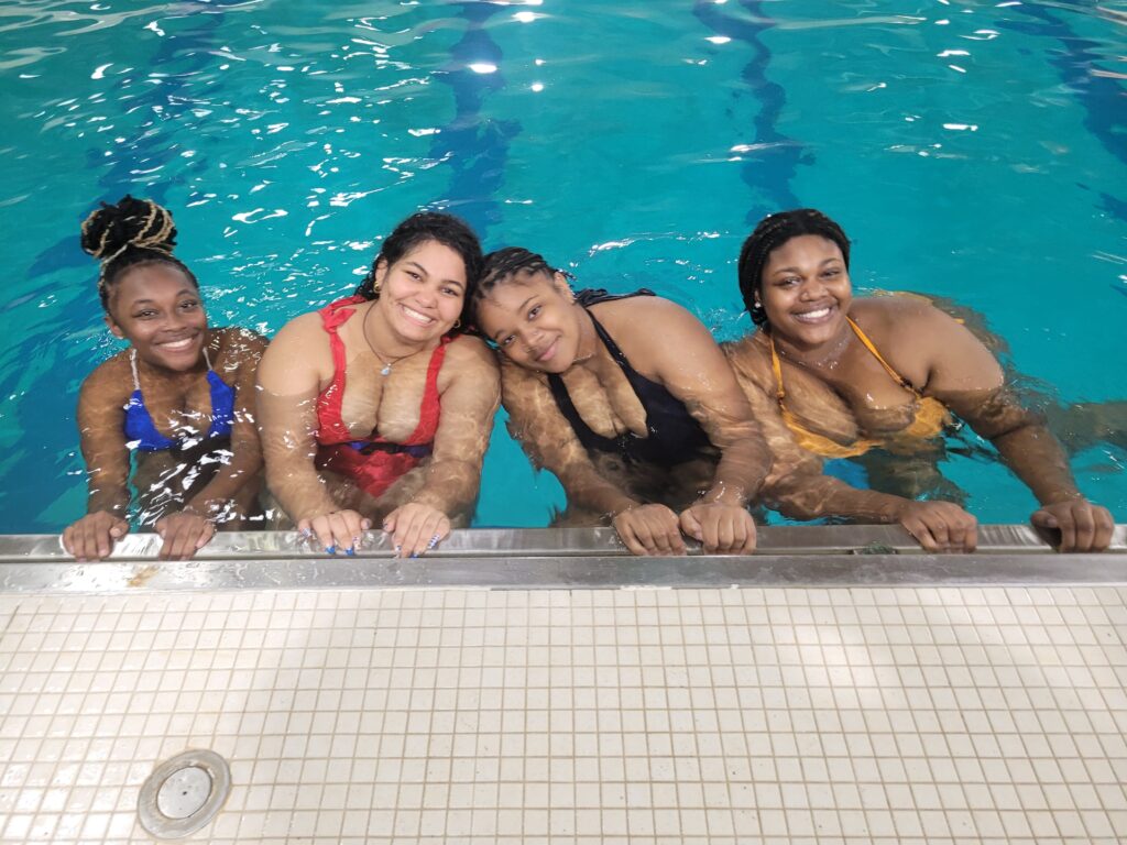 Four African American girls swimming